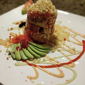 Tuna tartare with avocado, spicy sauce, and garnishes at Thai Lotus Restaurant.