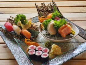 Assorted fresh sushi platter with sashimi, rolls, and garnishes at Thai Lotus Restaurant.