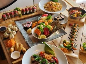 Fresh assorted sushi platter with vibrant ingredients and traditional Thai dishes served on elegant.