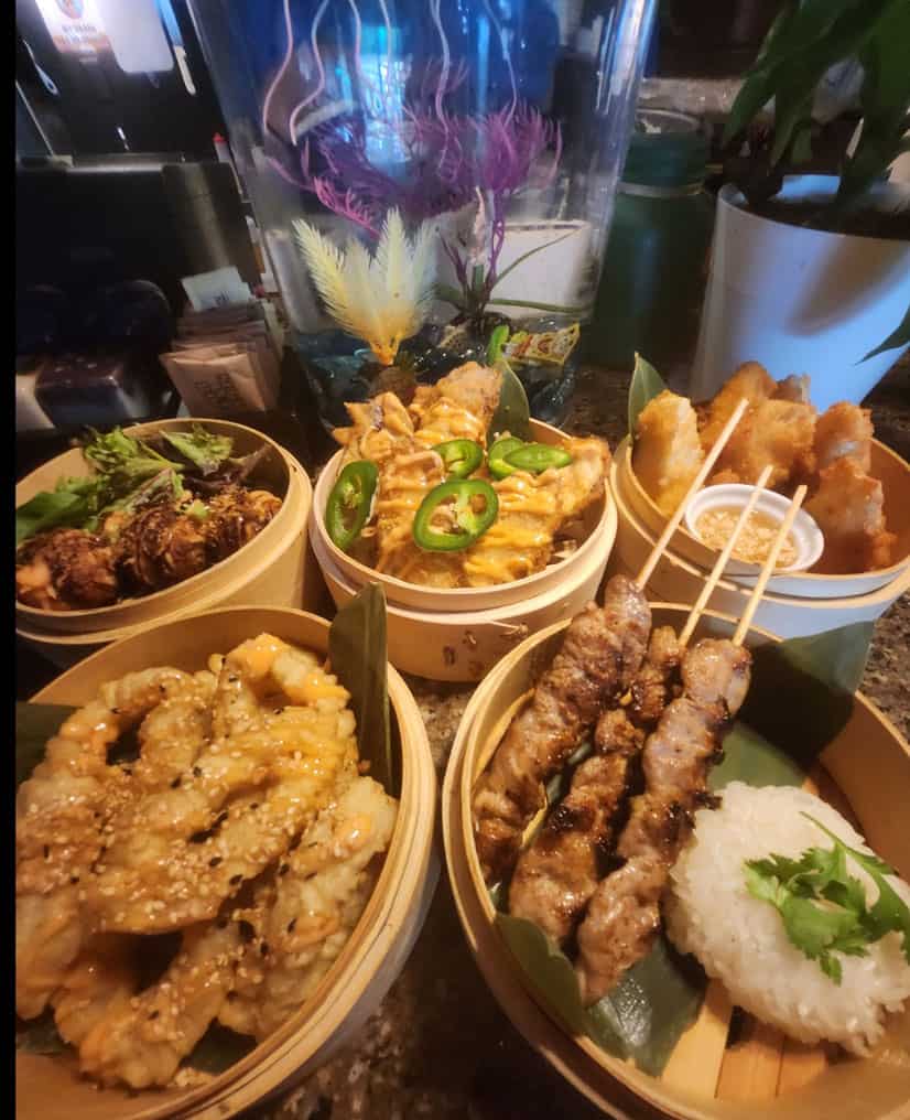 Authentic Thai dishes including grilled skewers, fried appetizers, and flavorful stir-fries at Thai.